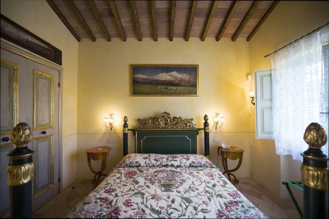 Comfortable room with canopy beds, simple decor, and natural lighting.