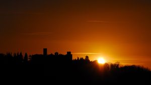 Sunset at Giomici Castle, a historic building surrounded by the tranquility of the Umbrian countryside.