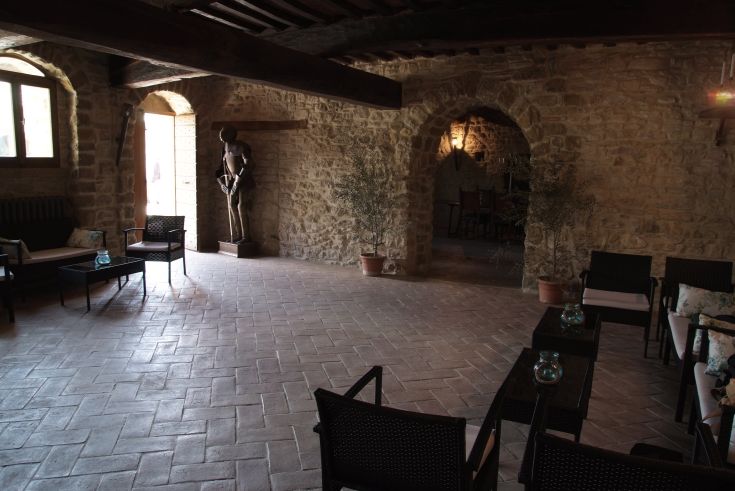 Interior of a palace with stone walls and simple decorations. The atmosphere is welcoming and tidy.