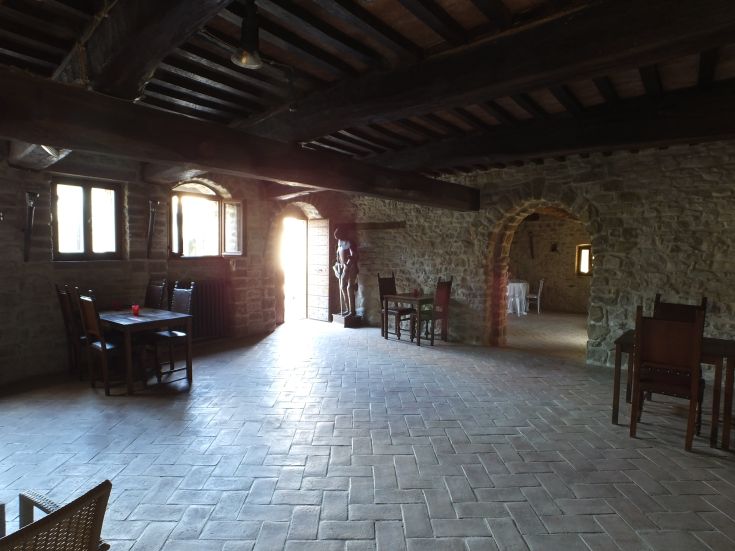 Interior of Palazzo Giomici, showcasing historical architectural details and a rustic atmosphere.