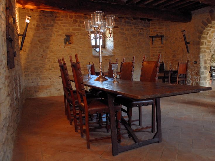 A simple dining room with a wooden table and matching chairs, perfect for gatherings.