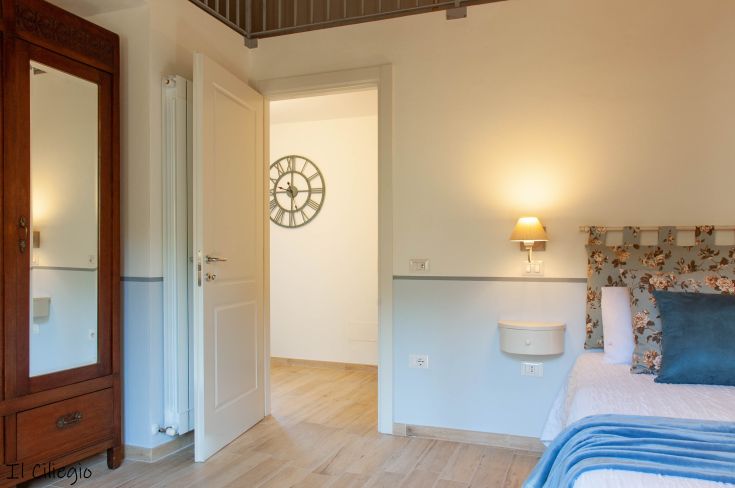 Rustic agriturismo room with simple furnishings and well-kept details. Warm and inviting atmosphere.