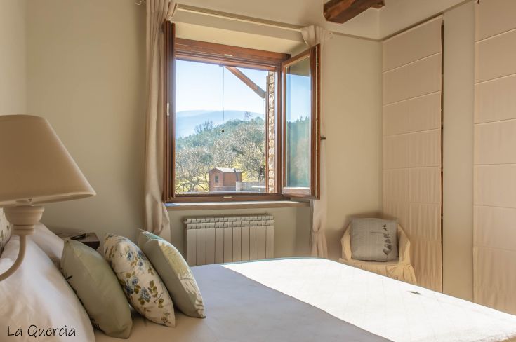Spacious room with a large window offering a scenic view of the surrounding nature, perfect for relaxation.