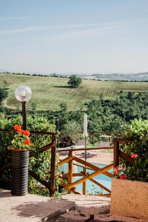 A building with a pool surrounded by green landscape.