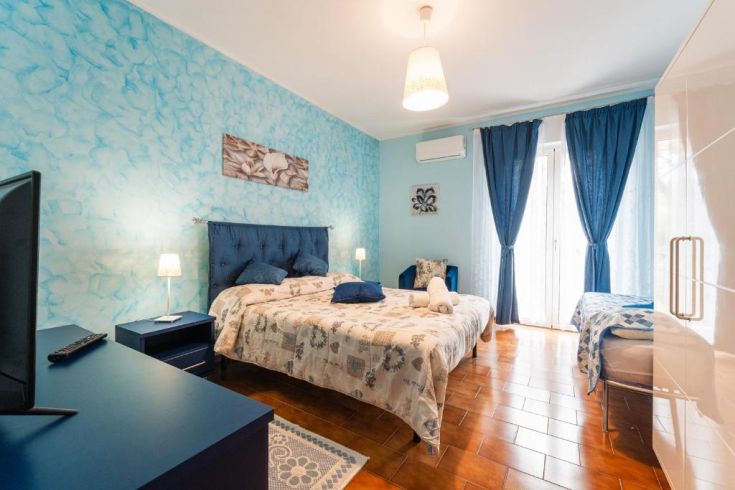Simple room with blue walls and understated decor, suitable for relaxation.