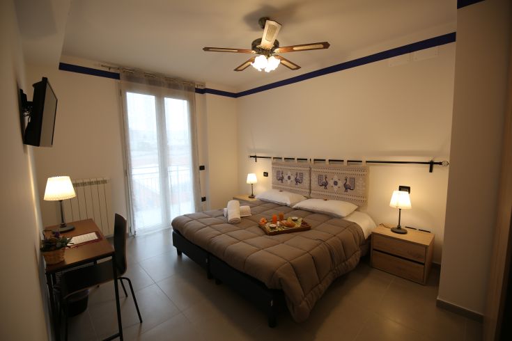 Comfortable bedroom with a double bed and garden view, perfect for a peaceful stay.