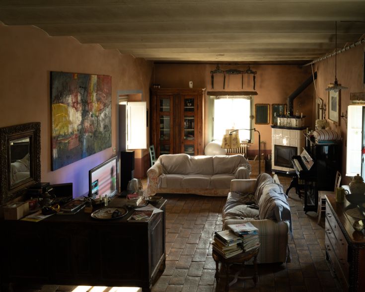 Innenansicht eines Bauernhauses, das durch eine helle Atmosphäre mit rustikalen Elementen und einfachen dekorativen Details gekennzeichnet ist.