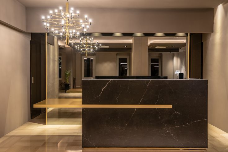 A contemporary hotel reception featuring stylish design and carefully considered lighting.