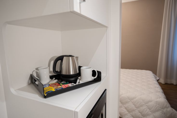 A simple space with a teapot and cups, perfect for a coffee break.