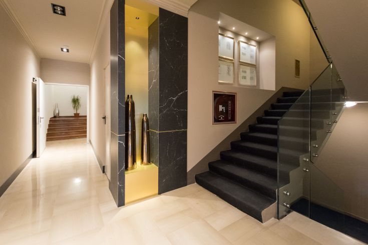 Interiors of a hotel featuring simple decor and stairs.