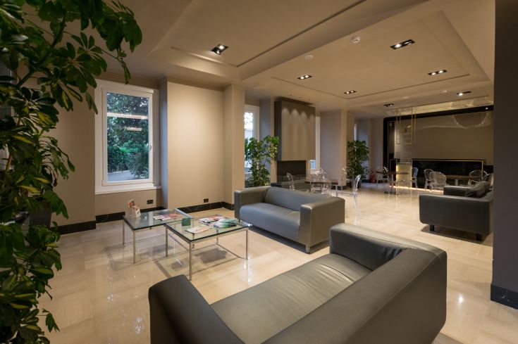 A cozy living room with comfy sofas and decorative plants, creating a warm atmosphere.