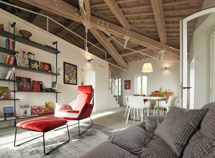 Spacious living room with wooden ceiling and contemporary furniture, perfect for relaxation and social gatherings.