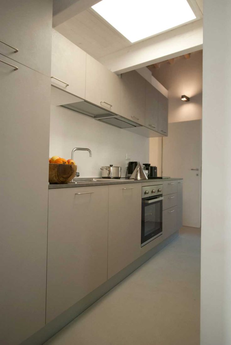 Modern kitchen with contemporary design, equipped with appliances and tools for various cooking preparations.
