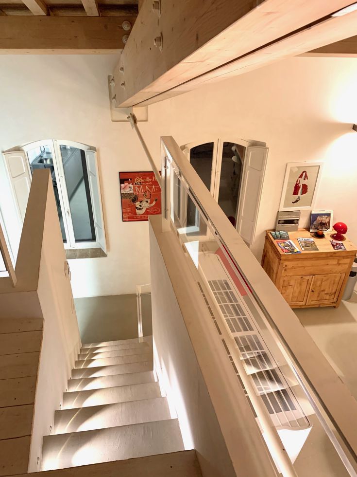 A well-lit interior of a home, featuring modern design elements and stairs.