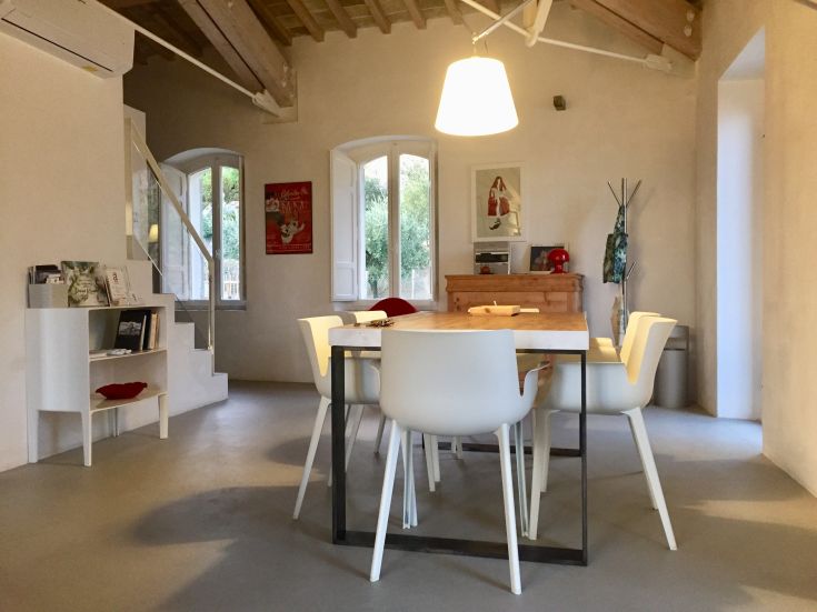 Spacious living room with dining table, modern decor, well-lit and cozy.