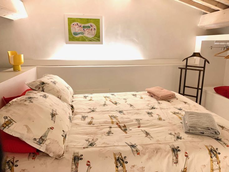 A peaceful room featuring a double bed, simply yet comfortably furnished.