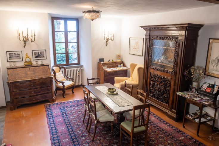 An interior of a historic house, featuring traditional furnishings and decorative details.