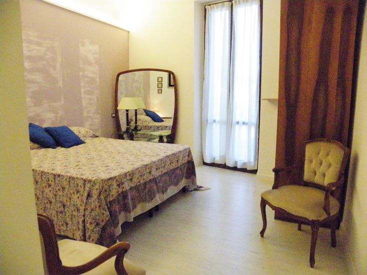 Einfache Zimmer mit Betten und einigen Vintage-Dekorationen, ideal für einen komfortablen Aufenthalt.