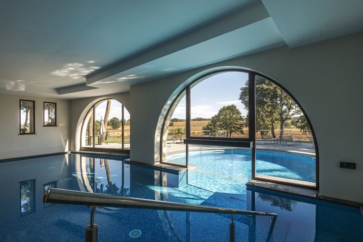 Una piscina interna che si affaccia sulla campagna circostante, creando un ambiente tranquillo e rilassante.