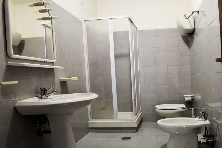 Well-kept bathroom featuring a shower and sink, with a tidy and practical environment.