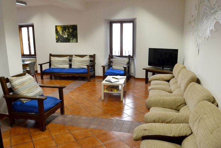 Common area with comfy sofas and TV, perfect for relaxation and group socializing.