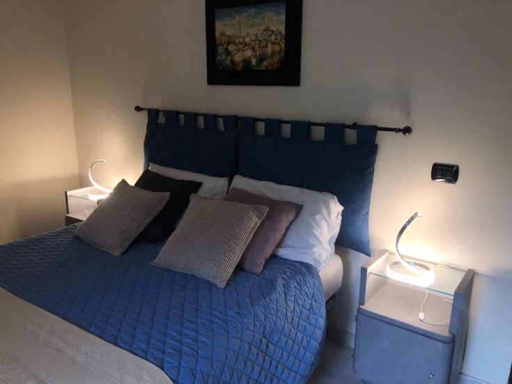 Simple room with comfortable beds, modest decor, and warm light. Ideal space for relaxation.