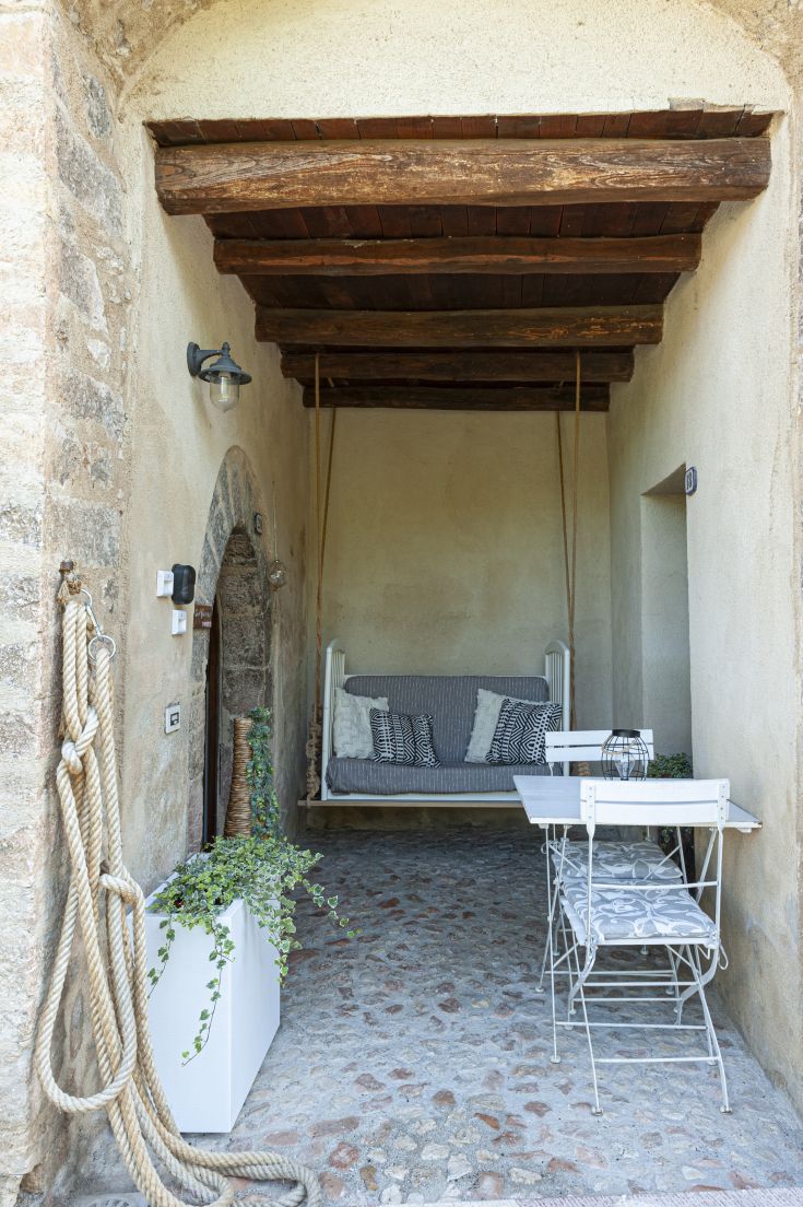 Peaceful outdoor space featuring a swing and a table for enjoying outdoor relaxation.