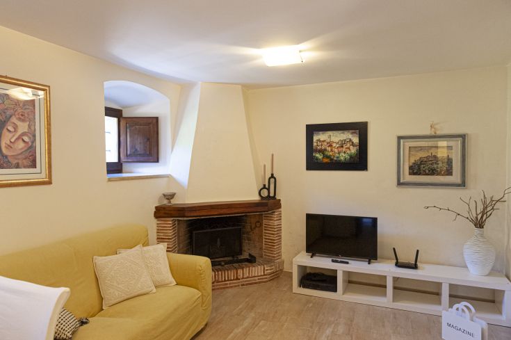 Cozy living room with a fireplace and traditional decor, perfect for relaxing moments.