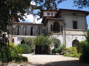 A historic building surrounded by green areas, creating a serene atmosphere and pleasant environment.