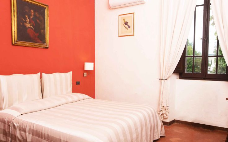 Cozy room with a red wall and simple details, devoid of any artistic decorative elements.