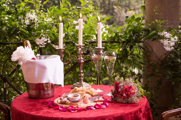 An intimate setting with a nicely set table and simple floral decorations.