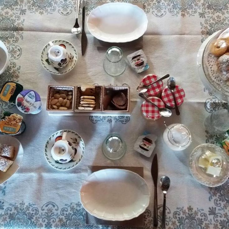 A beautifully set breakfast table featuring pastries, coffee, and a relaxing atmosphere.