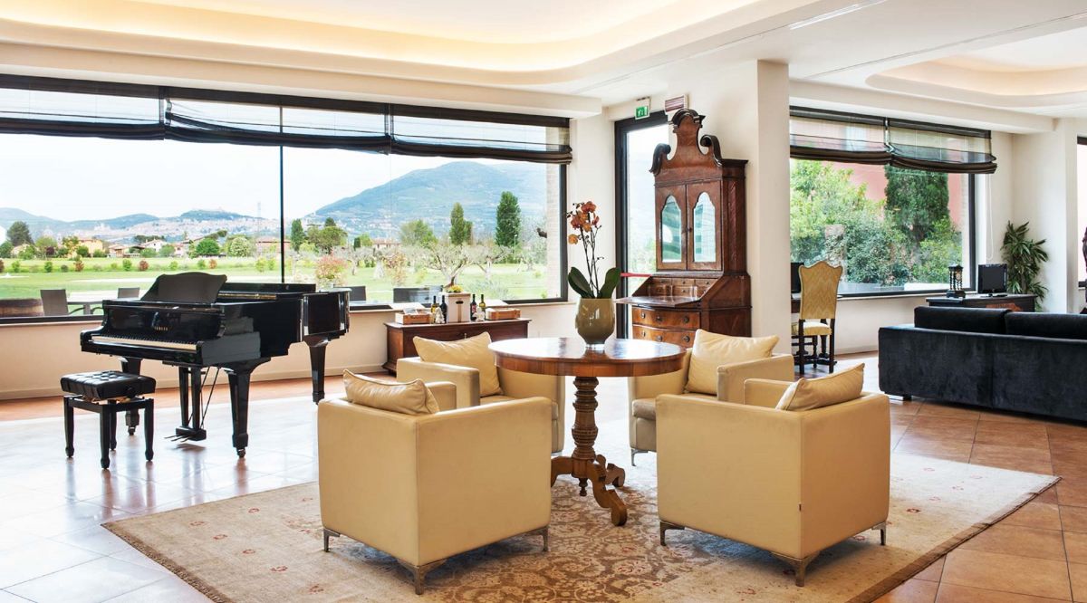 Cozy living room with a piano and a lake view, perfect for relaxation and socializing.