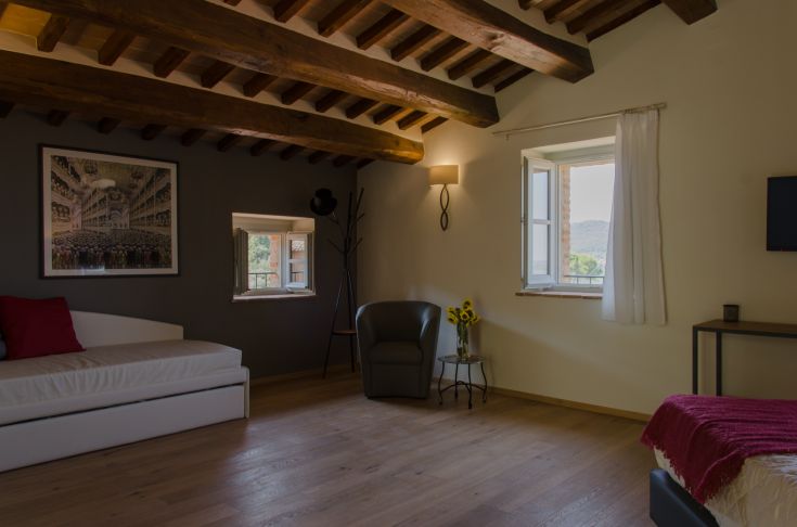 Cozy room with wooden beams, simple furnishings, and rustic details.