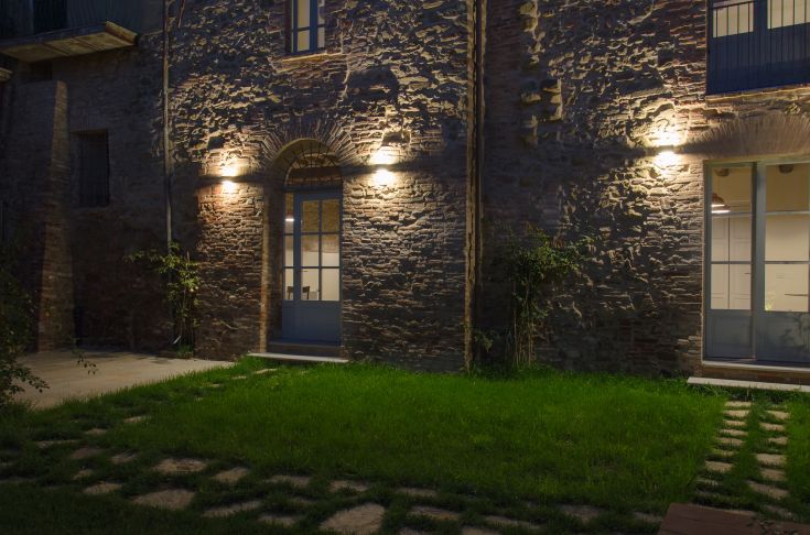 The exterior of Antico Sipario, a historic boutique hotel surrounded by a well-maintained garden.