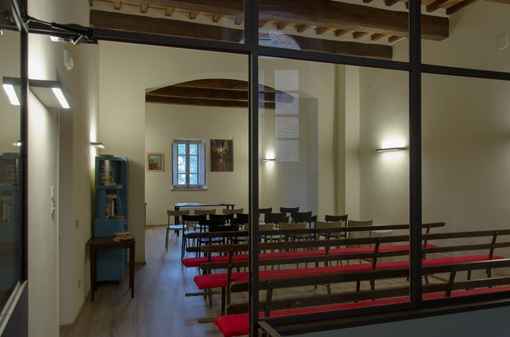 A serene conference room in a building, featuring wooden details and soft lighting.