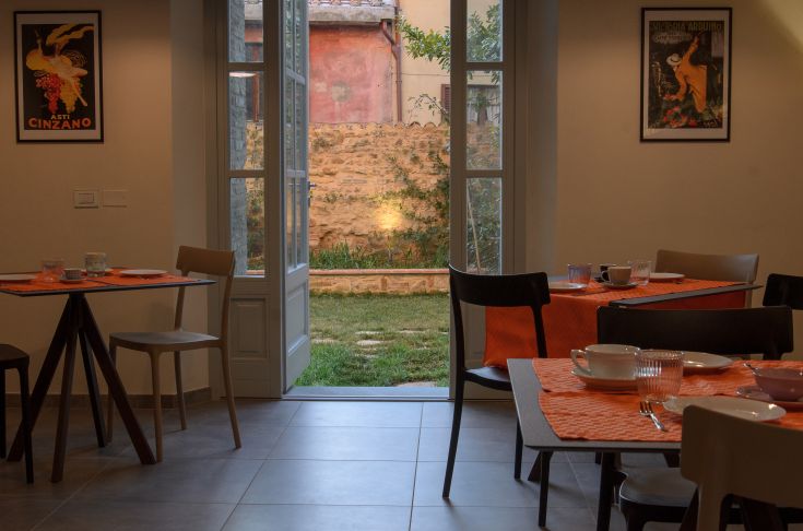 Restaurant with garden access, simple decor, and a calm atmosphere.