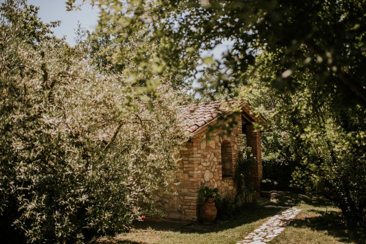 A stone building surrounded by trees and greenery, perfect for those seeking a peaceful countryside environment.
