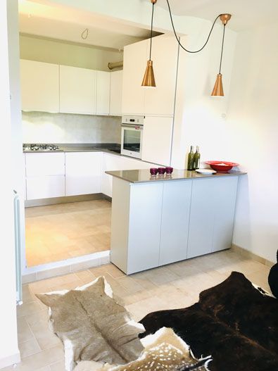 Bright interior of a simple kitchen featuring a functional central island.