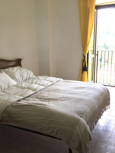 Cozy bedroom with yellow curtains creating a warm and inviting atmosphere.