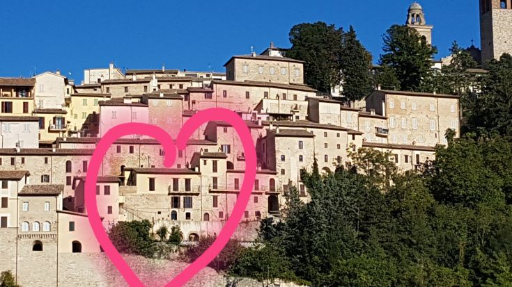 A panoramic view of historic buildings surrounded by lush greenery and vibrant trees.