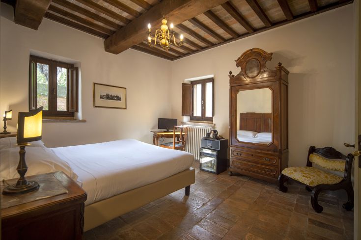Cozy room with wooden beams, terracotta floors and traditional decor.