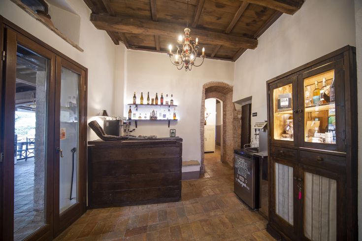 Welcoming entrance featuring wooden elements and a cozy bar area designed for guest comfort.