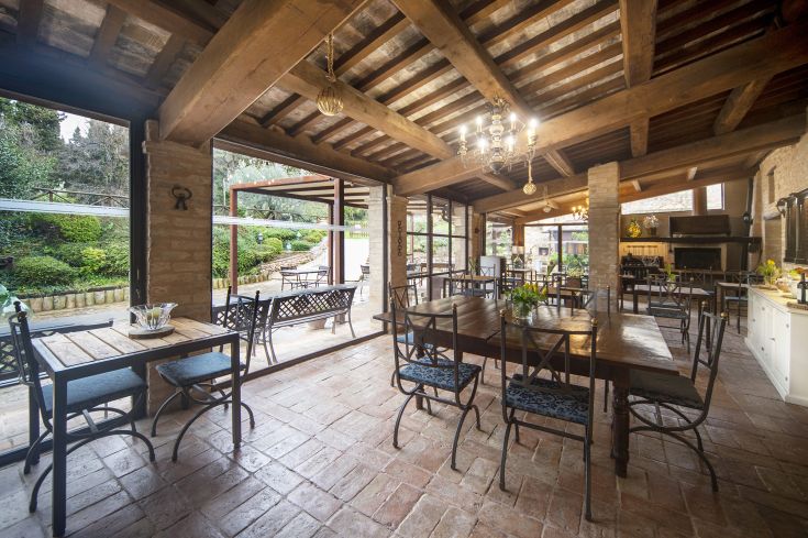 Rustic interior with exposed beams and large windows, perfect for events and gatherings.