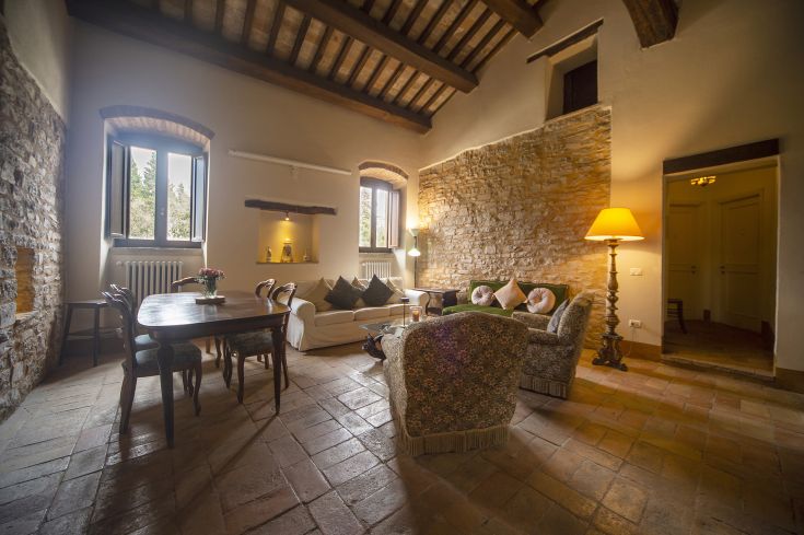 Interior of a restored Umbrian farmhouse, featuring stone walls and rustic decor elements.