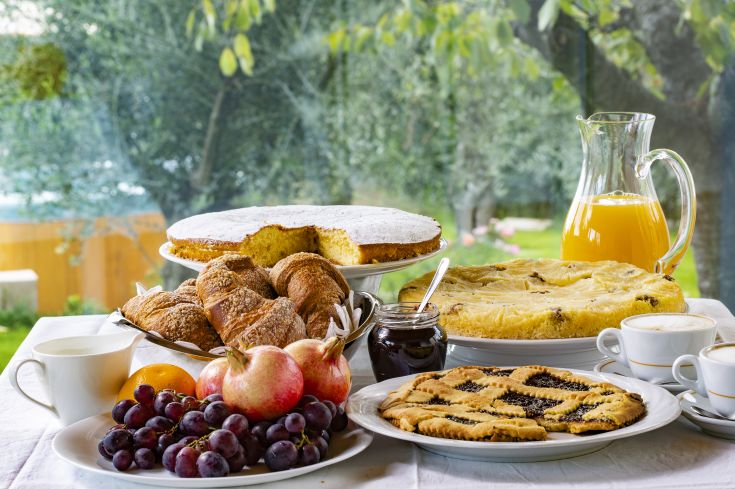 A brunch with sweets, fresh fruit, and beverages, perfect for a relaxing moment.
