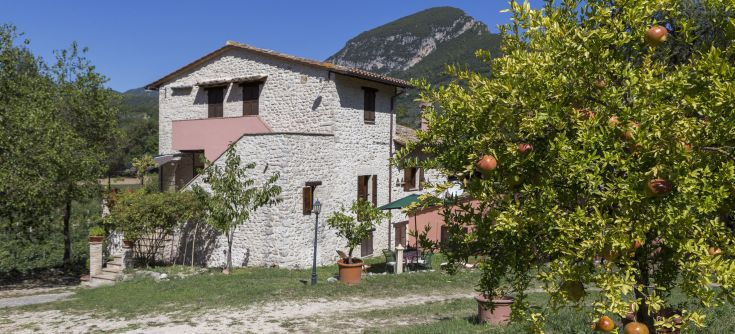 Stone building surrounded by a garden, perfect for a relaxing moment in nature.