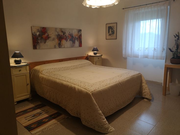 A simple room with comfortable beds and soft lighting.