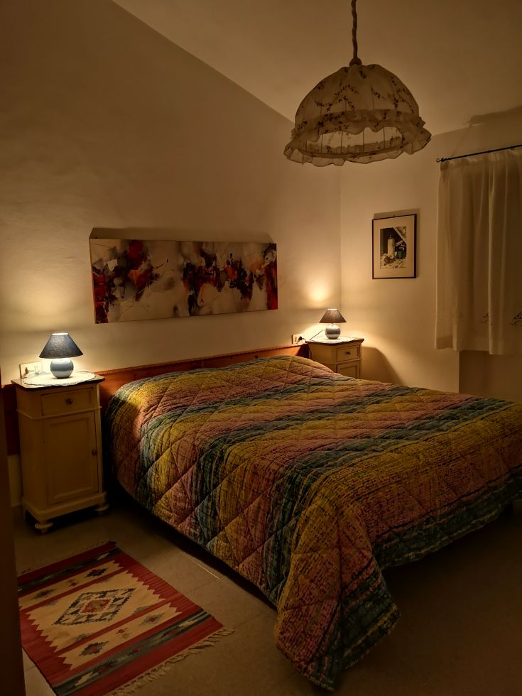 Simple room with soft-colored beds, gentle lighting, and a serene atmosphere.