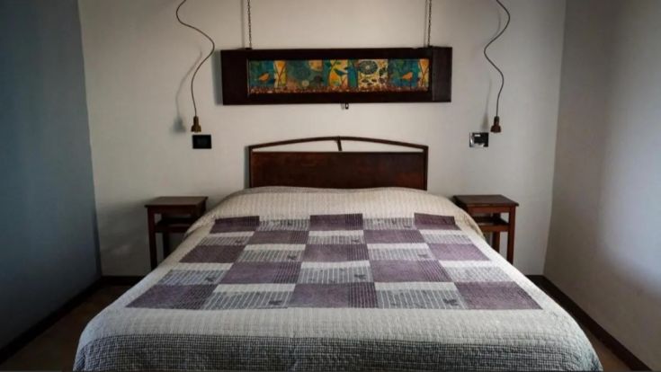 A simple bedroom featuring a double bed and contemporary furnishings, perfect for a relaxing stay.